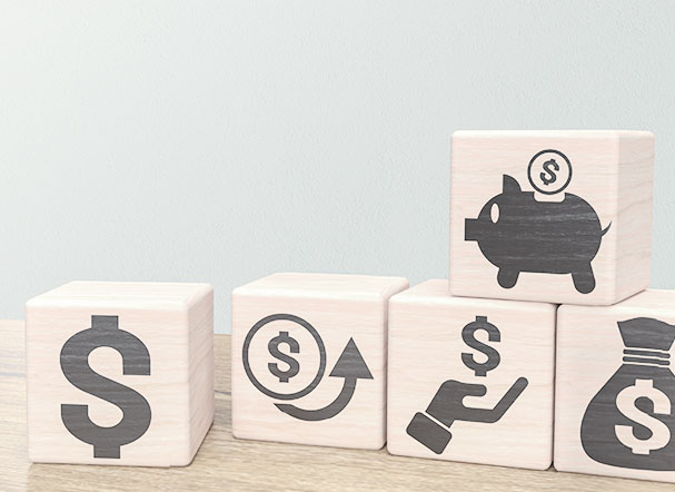 3D wooden cubes with graphic prints of symbols representing money