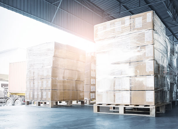 Photograph of a cargo port, with several brown, stacked boxes
